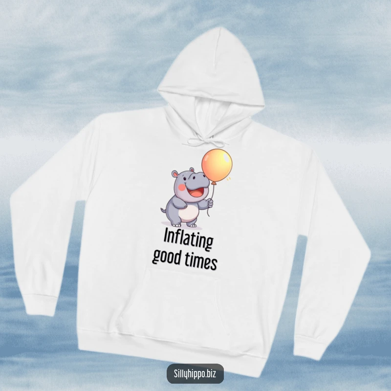 Funny Hoodie illustration of a happy hippo with great enthusiasm inflating a large, colorful balloon, full of joy.