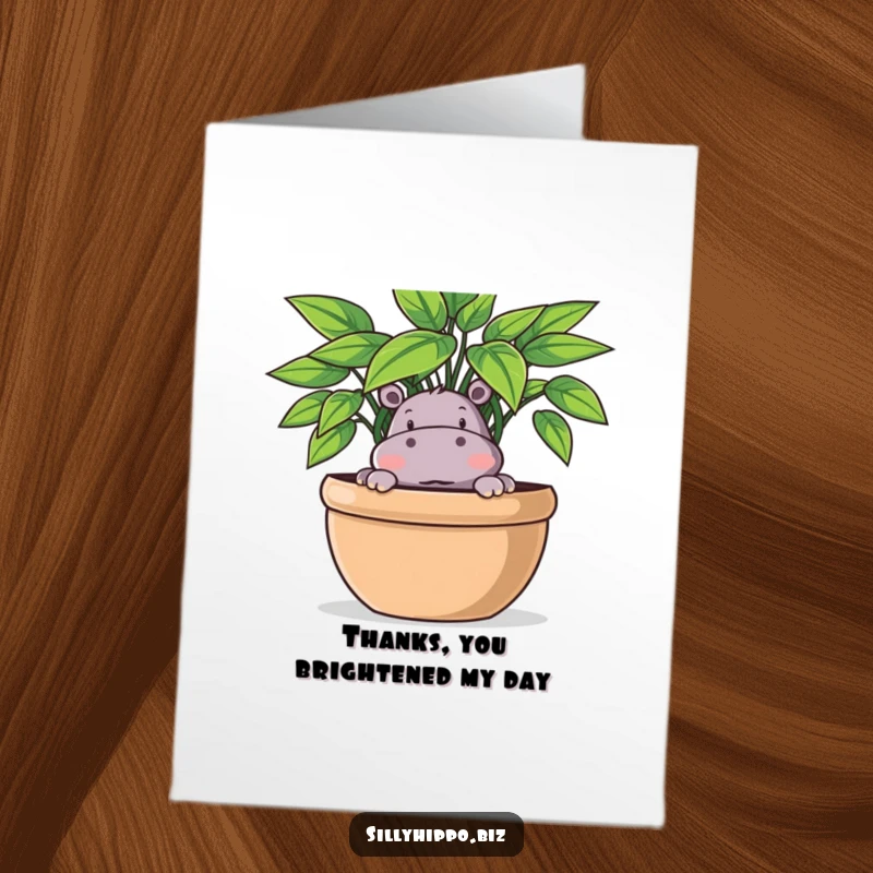 Funny Free Printable thank you card showing a playful hippo partially hidden behind a large potted plant, offering a sweet surprise.
